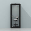Quell Acoustic Plus Soundproof pod in charcoal, light blue background, light office workspace